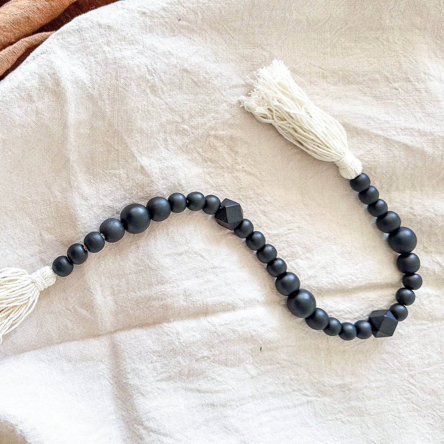 Adorno cuentas madera negras con borlas blancas Adorno Frank Home Chile